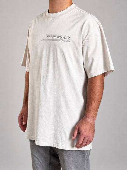 Hebrews 4:12 tee in Faded Bone, side angle on a male model showing the dropped shoulders and chest print