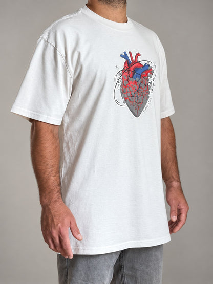 Ezekiel 11:19 tee in Faded Bone, side angle on a male model showing the dropped shoulders and heart print