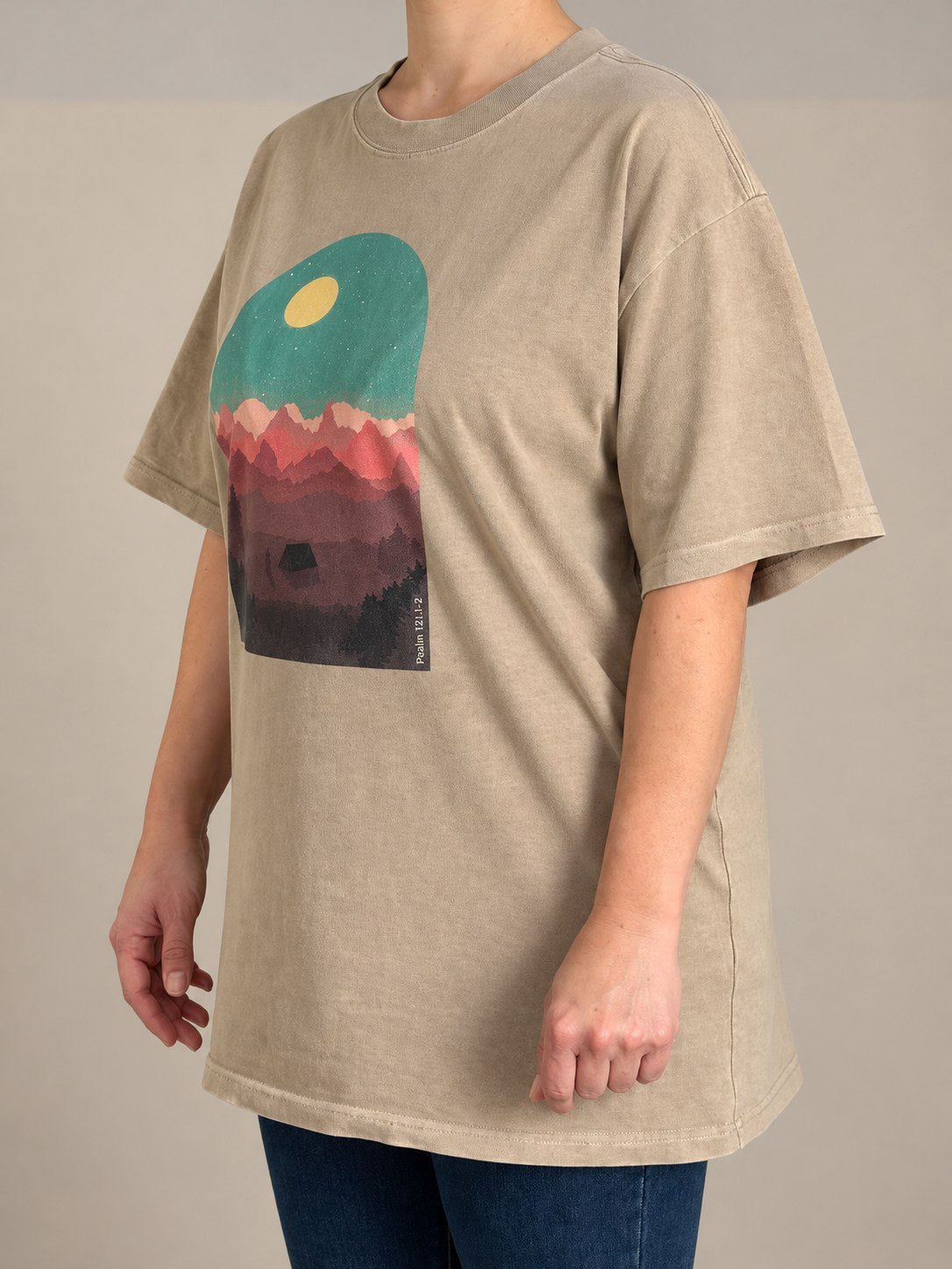 Psalm 121:1-2 tee in Faded Khaki, side angle on a female model with the dropped shoulders and mountain print
