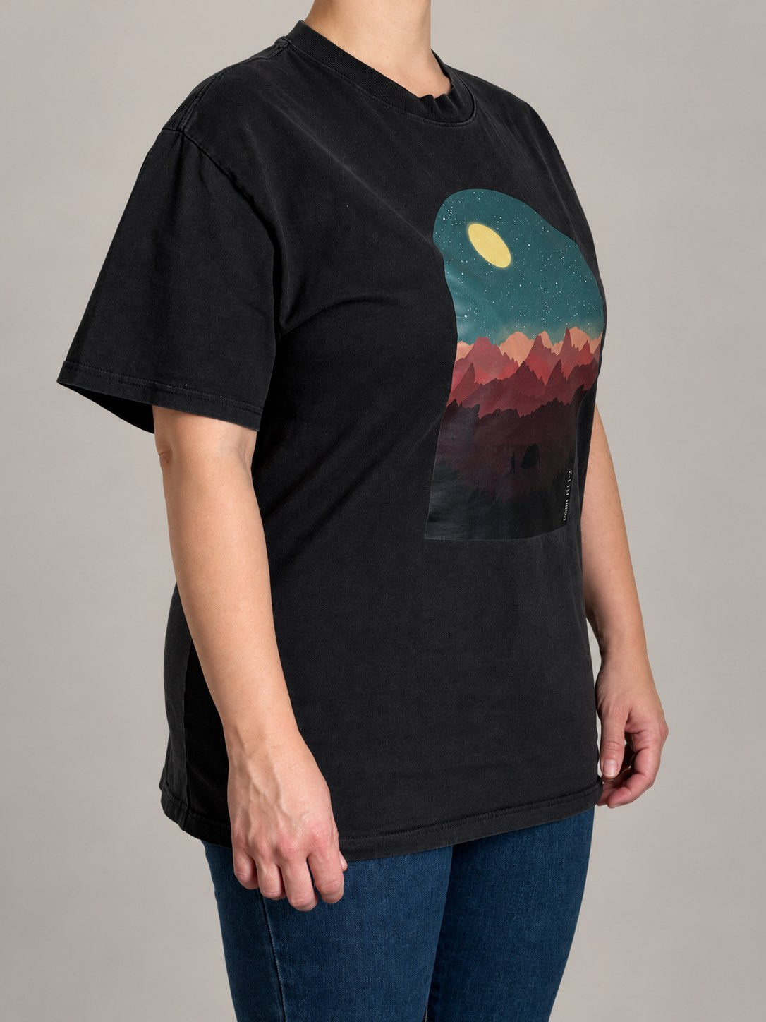 Psalm 121:1-2 tee in Faded Black, three-quarter view on a female model showing the boxy oversized fit