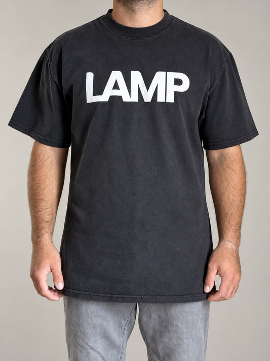 Lamp oversized faded tee in Faded Black with the large white LAMP lettering on the chest, front view on a male model