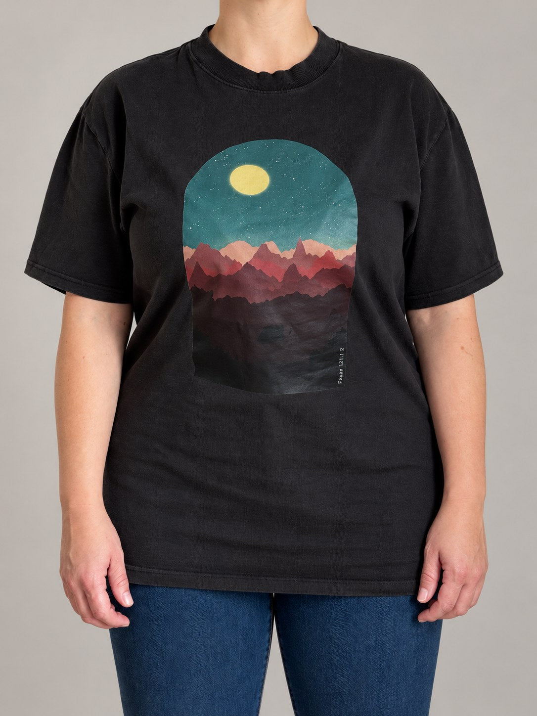 Psalm 121:1-2 oversized faded tee in Faded Black, front view on a female model, moonlit mountain scene print